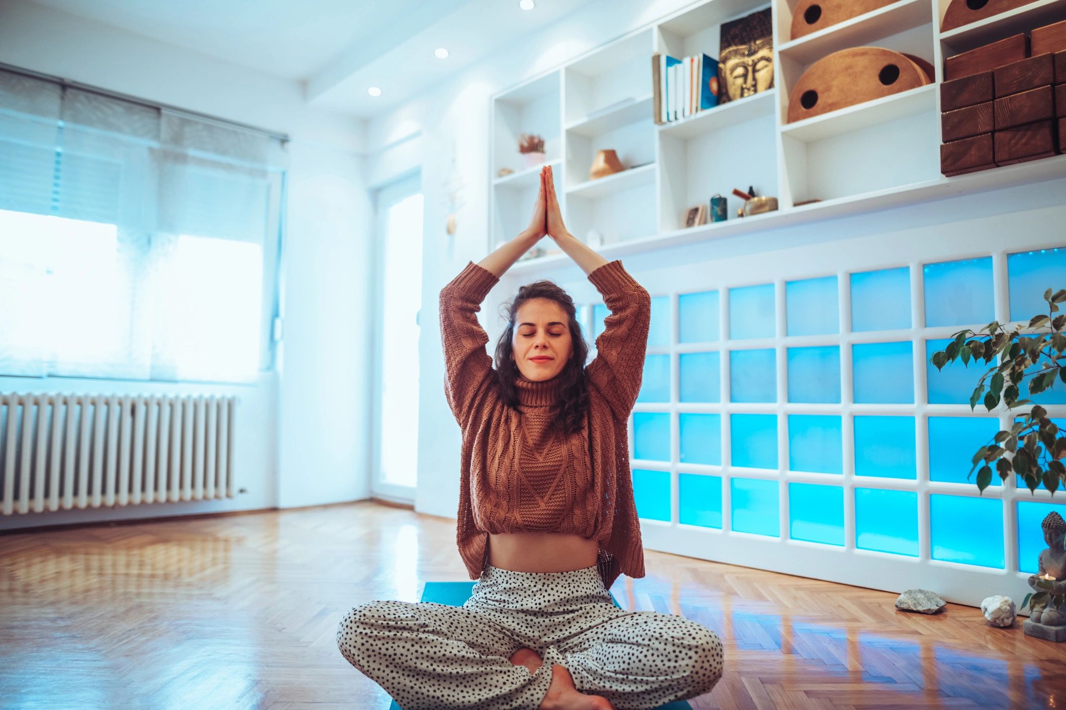 Person meditating in a calm yoga studio