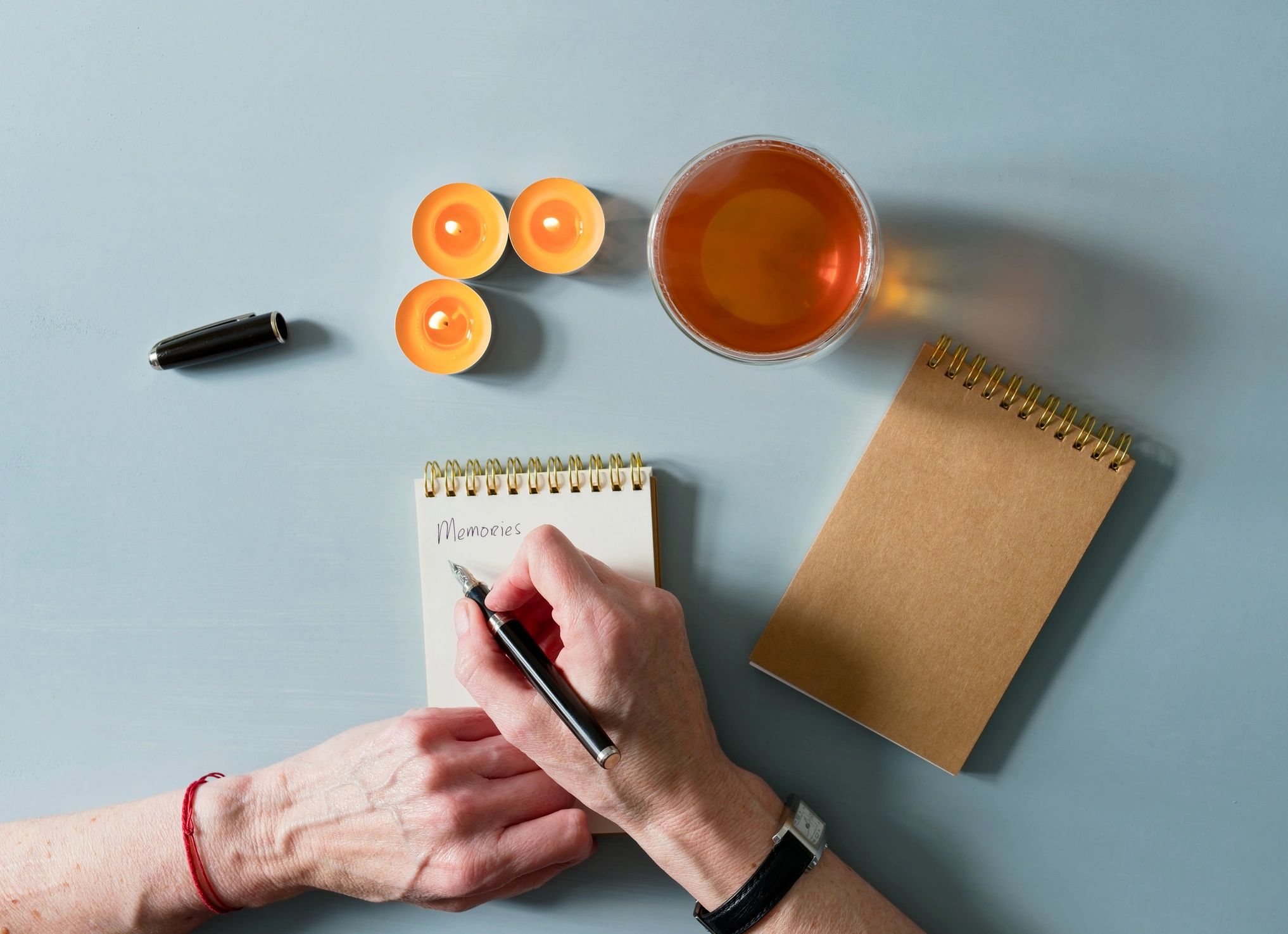 Mindfulness journaling with tea and candlelight